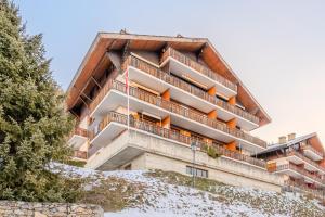 an apartment building on top of a snow covered hill at Greppons P 011 - MOUNTAIN apartment 6 pers in Veysonnaz