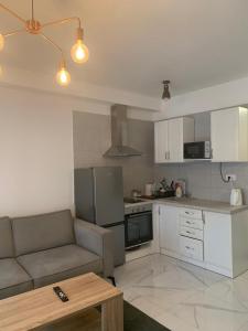 a living room with a couch and a kitchen at Green lime in Tivat