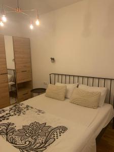 a bedroom with a bed with a black and white blanket at Green lime in Tivat