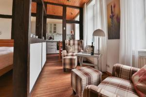 een woonkamer met een bank en stoelen en een keuken bij Hof Wiesentau in Bösdorf