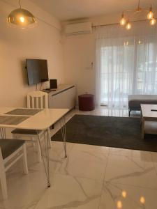 a living room with a table and a couch at Green lime in Tivat +6 photos