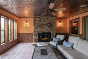 a living room with a couch and a fireplace at Stony Crest Cabin Deer Lake in Three Lakes +8 photos