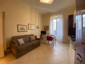 a living room with a couch and a table at Casa Elena - Centro Diano Marina in Diano Marina