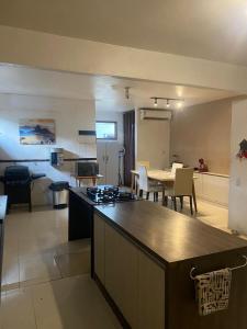 a kitchen and living room with a table and a kitchen and a dining room at Suíte na casa amazônica in Manaus