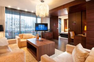 a living room with a couch and a tv at Tallink Hotel Riga in Riga