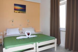 a bedroom with a bed with a swan on it at Litinas Apartments with pool in Agia Marina Nea Kydonias +83 photos