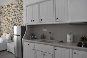 a kitchen with a sink and a refrigerator at Chora Cozy Studios - Kythnos in Kithnos