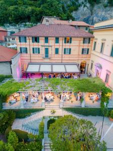 an overhead view of a building with people sitting at tables at Hotel Villa Cipressi, by R Collection Hotels in Varenna +54 photos