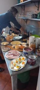 a table with plates of food on it in a kitchen at WILLA MONTE NEVE in Stronie Śląskie