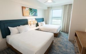a hotel room with two beds and a window at Holiday Inn Club Vacations Myrtle Beach Oceanfront in Myrtle Beach