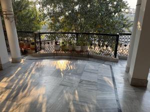 a balcony with potted plants on a fence at Double room with balcony in Prayagraj