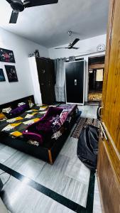 a bedroom with two beds and a ceiling at Double room with balcony in Prayagraj