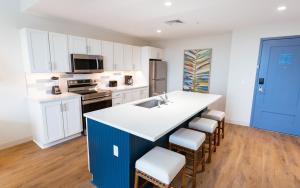 a kitchen with white cabinets and a blue island at Holiday Inn Club Vacations Myrtle Beach Oceanfront in Myrtle Beach
