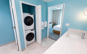 a bathroom with a washer and dryer in a room at Holiday Inn Club Vacations Myrtle Beach Oceanfront in Myrtle Beach
