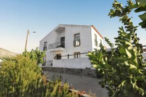 a white house with a lot of plants at Luxurious House in Corte de Pao with Private Pool in Corte de Pão e Água