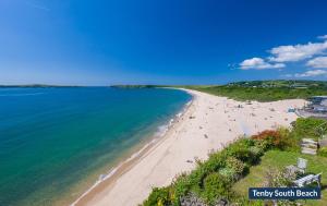 an aerial view of a beach with people on it at Little Mead in Amroth