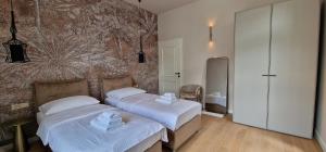 a bedroom with two beds and a wall mural at Luxury Nobile Apartment with private parking in Opatija