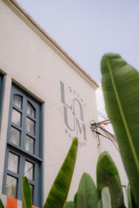 a building with a sign on the side of it at Poblado Luum Boutique hotel in Medellín