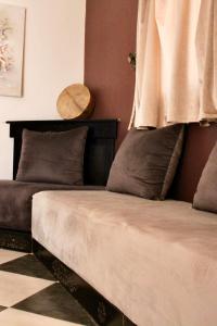 a bedroom with two beds and a mirror on the wall at Peak House Imsouane in Imsouane