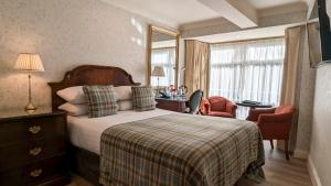 Ένα ή περισσότερα κρεβάτια σε δωμάτιο στο Granville Hotel