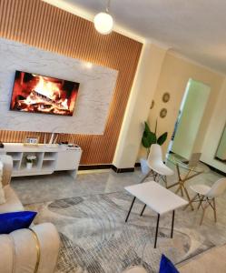 a living room with a fire in the wall at Minstan towers in Nairobi