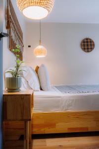 a bedroom with a bed with white sheets and pillows at Poblado Luum Boutique hotel in Medellín +64 photos
