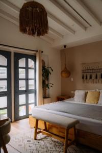 a bedroom with a bed and a large window at Poblado Luum Boutique hotel in Medellín