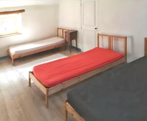 a room with two beds and a window and a door at Maison spacieuse avec sauna à Héricy de 230 m² in Héricy