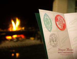 a book with stickers on it in front of a fire at B&B Stupor Mundi in Altamura