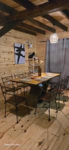 a table and chairs in a room with a wooden wall at Laslu in Punta Del Diablo