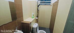 a small bathroom with a toilet and a shower at Vintage Houze, fully aircond, Wi-fi, Netflix, Coway in Alor Setar +17 photos