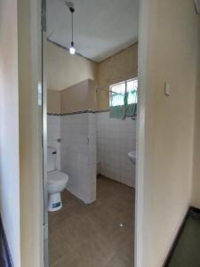 a bathroom with a toilet and a sink at Holy Spirit Mission Camps in Mount Lavinia