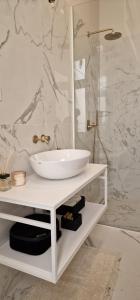 a white bathroom with a sink and a shower at Luxury Nobile Apartment with private parking in Opatija +51 photos