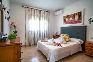 a bedroom with a large bed with a blue headboard at Villa Adelina en Turre, Almería, Villa de lujo con piscina privada cerca de las playas de Mojácar in Turre +39 photos