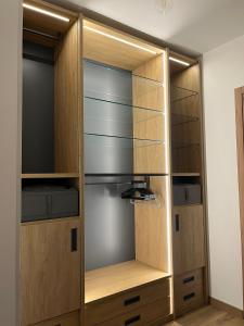 a closet with wooden doors and shelves at Humanitas & Forum - CASA TUA Housing in Rozzano