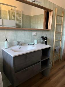 a bathroom with a sink and a mirror at Humanitas & Forum - CASA TUA Housing in Rozzano +41 photos