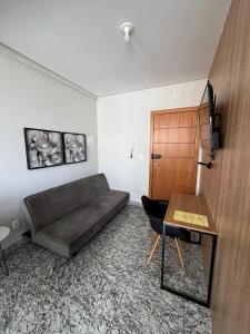 a living room with a couch and a table at LK Lourdes 12 in Belo Horizonte