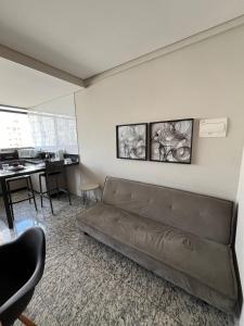 a living room with a couch and a table at LK Lourdes 12 in Belo Horizonte