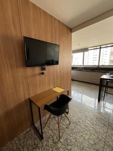 a room with a desk and a television on a wall at LK Lourdes 12 in Belo Horizonte +33 photos