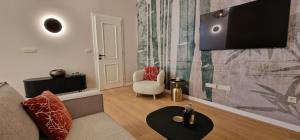 a living room with a couch and a chair at Luxury Nobile Apartment with private parking in Opatija