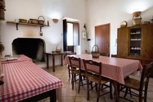 a dining room with a table and chairs and a fireplace at Autentico Agri Salento in Morciano di Leuca +35 photos