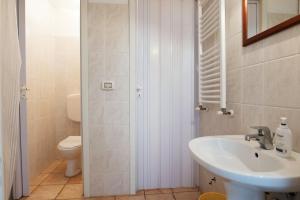 a bathroom with a sink and a toilet at Autentico Agri Salento in Morciano di Leuca