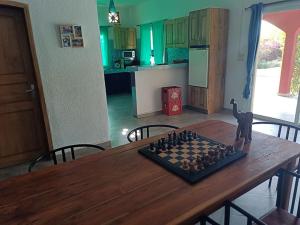 a chess board on a wooden table in a kitchen at Villa de luxe avec piscine au soleil du sénégal petite cote in Mbour