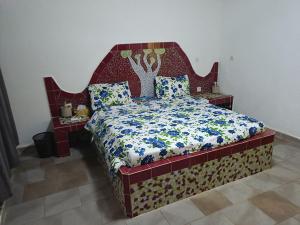 a bedroom with a large bed with a red headboard at Villa de luxe avec piscine au soleil du sénégal petite cote in Mbour +63 photos