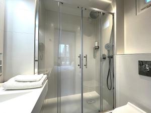 a bathroom with a shower with a glass door at Paris Saint Cloud Hôtel in Saint-Cloud +18 photos