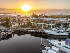 a group of boats docked at a marina at sunset at Inn at Camachee Harbor by CoolVacay in St. Augustine