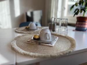 a table with two plates and a teapot on it at Wohnung am Neckar in Heidelberg