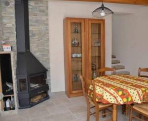 a room with a fireplace and a table with a bed at Maison conviviale avec piscine partagée à La Ciotat - 70 m² in La Ciotat