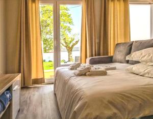 a bedroom with a bed and a large window at Charming House with Pool in Atalaia in Lourinhã +41 photos
