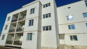 a white apartment building with a lot of windows at Apartament Alexandru Saturn in Saturn